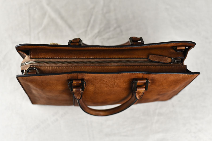 Brown leather briefcase on a light gray background