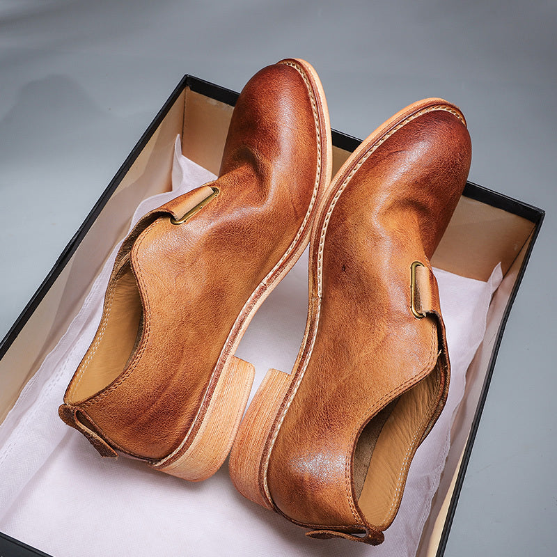 Pair of brown leather shoes in a box on a gray background