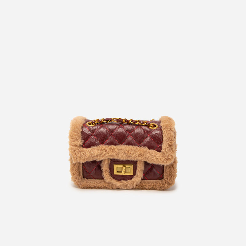 Dog toy shaped like a fur-trimmed handbag on a white background