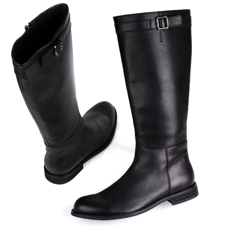 Pair of black knee-high boots with a buckle on a white background