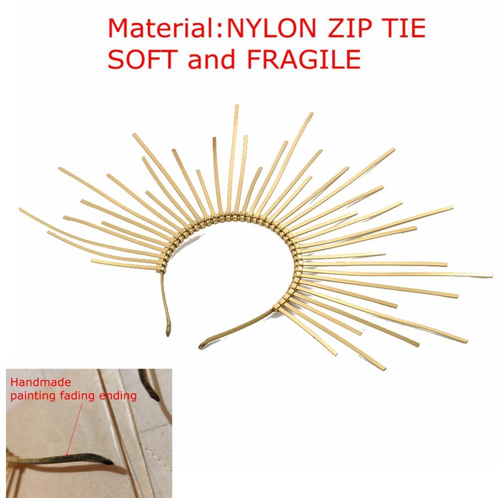 Gold sunburst headband with warning text about material and fragility on a white background.