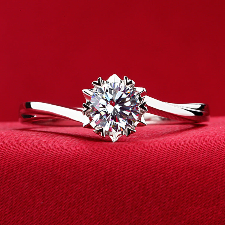 Silver ring with a large diamond on a red background