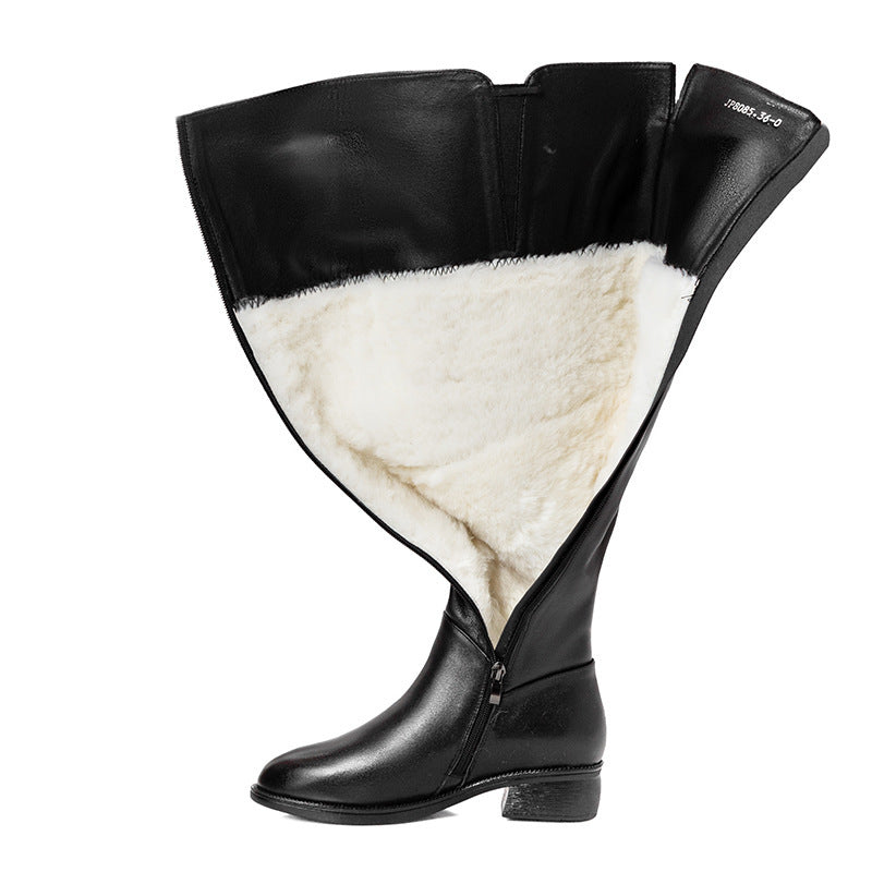 Black boot with white fur lining on a white background