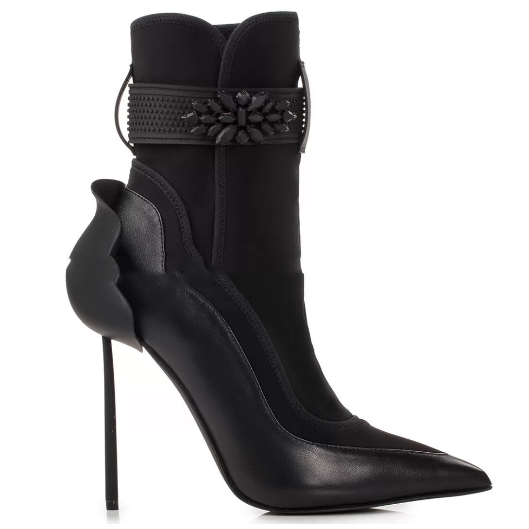 Black high-heeled ankle boots with decorative embellishments on a white background