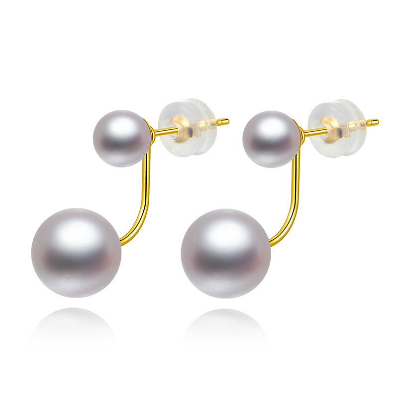 Pearl earrings with gold hooks on a white background