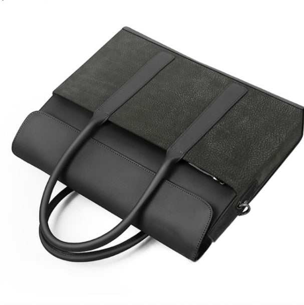 Black handbag with a strap on a white background