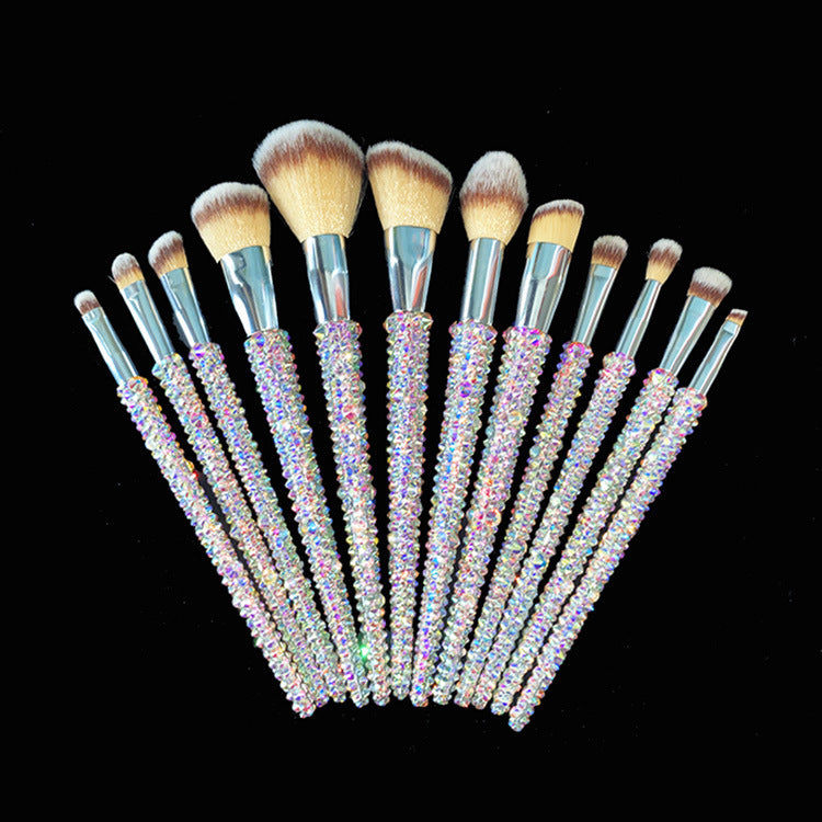 Makeup brushes with rhinestone handles on a black background