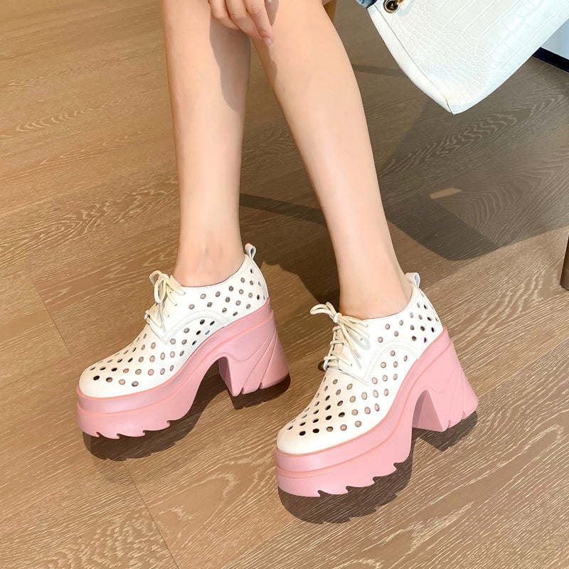 Pink and white platform shoes on a wooden floor