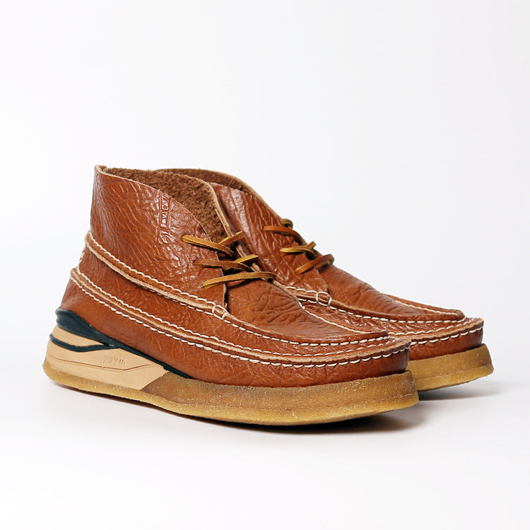 Brown leather shoes with a textured finish on a white background