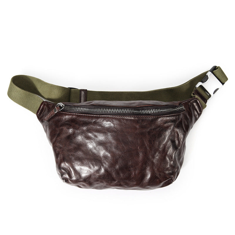 Brown leather waist bag with green strap on a white background