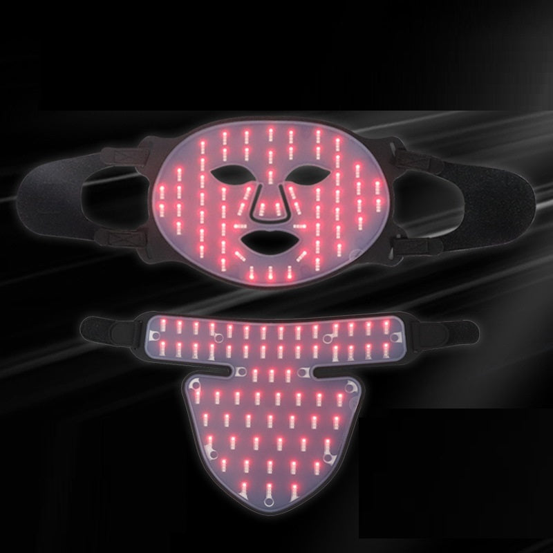 Two LED face masks with red lighting on a dark background