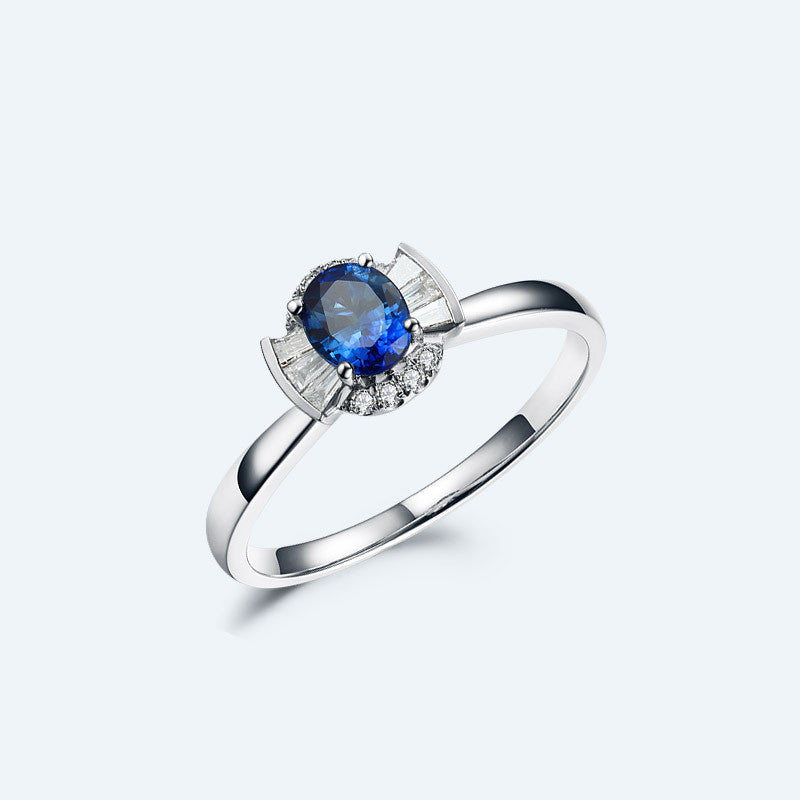Silver ring with a blue gemstone on a white background