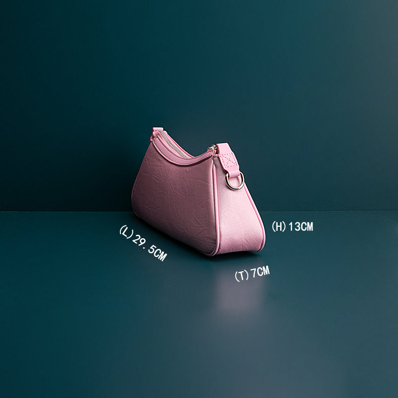 Pink handbag with measurements on a dark background