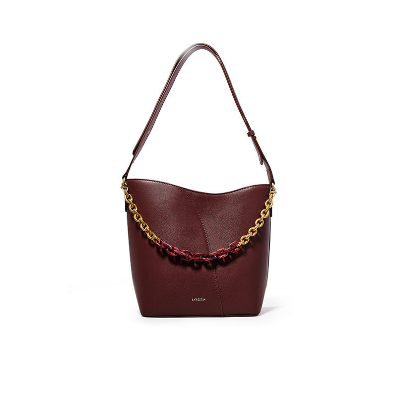 Brown handbag with gold chain detail on a white background