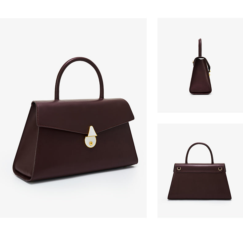 Brown handbag with a gold clasp on a white background