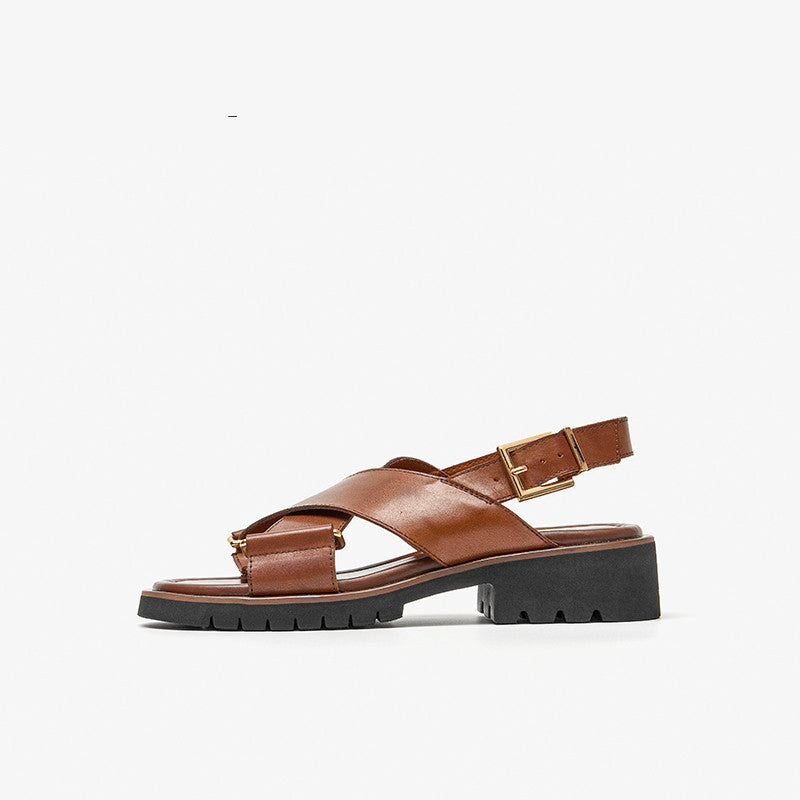 Brown sandal with a black sole on a white background