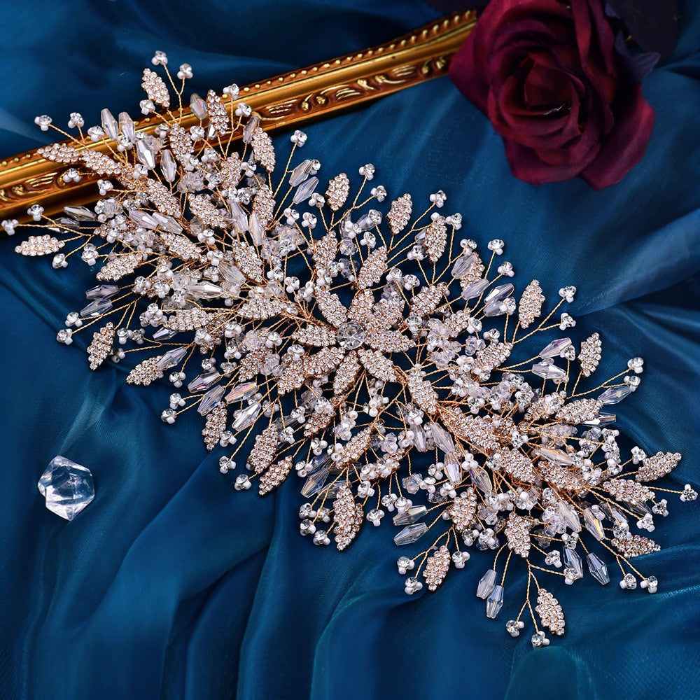 Decorative brooch with crystals on a blue fabric background