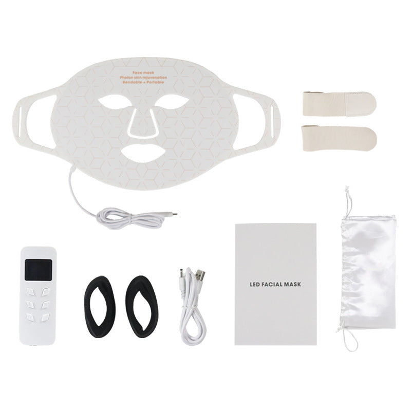 LED facial mask set with remote control, earbuds, and accessories on a white background