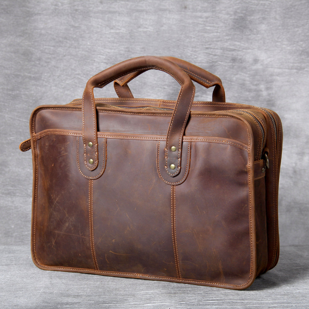 Brown leather briefcase on a gray background