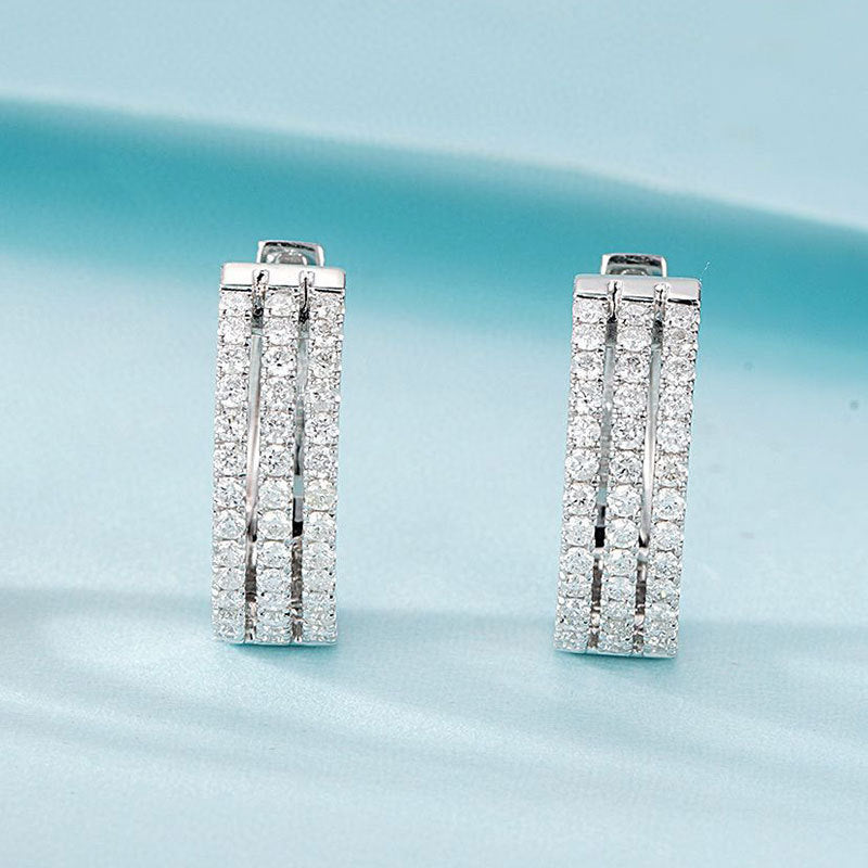 Pair of diamond earrings on a light blue background