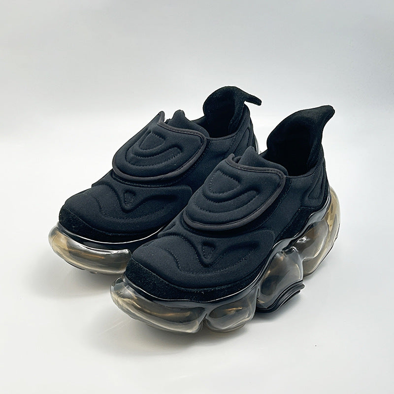 Black sneakers with transparent soles on a white background