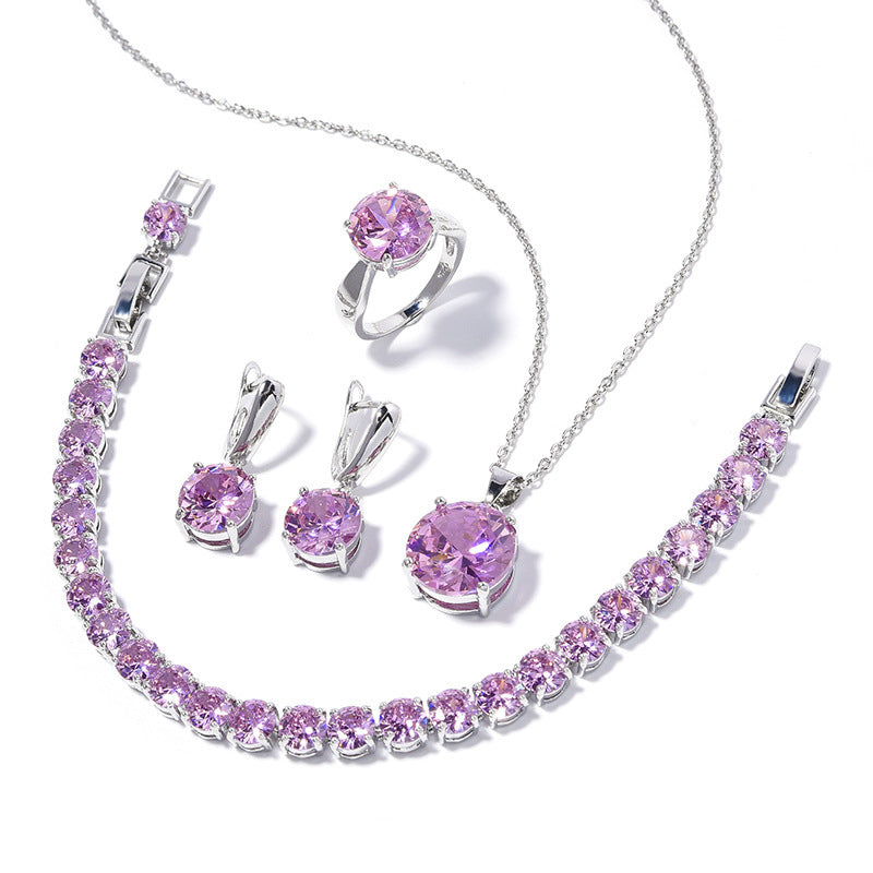Jewelry set with pink gemstones on a white background