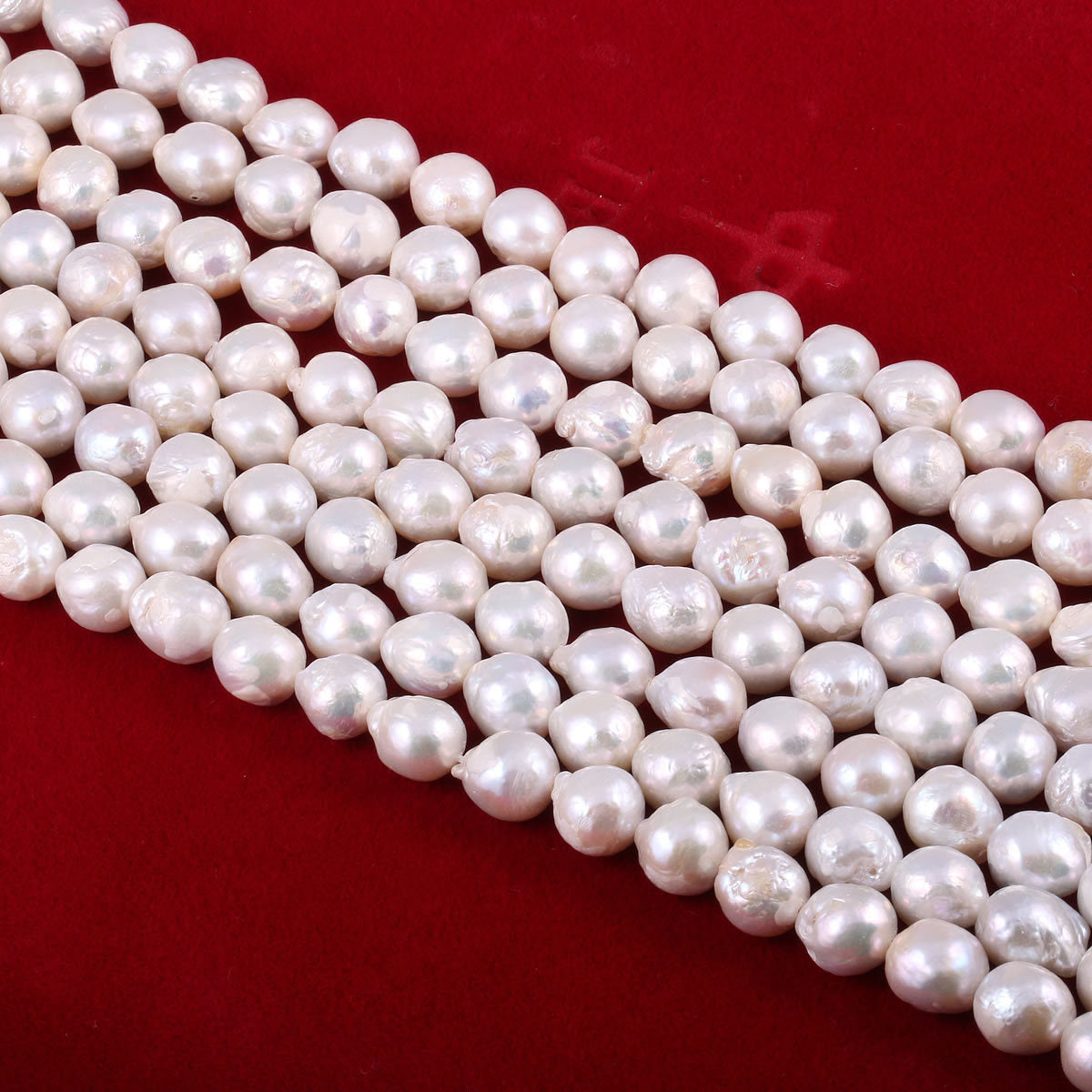 String of white pearls on a red background