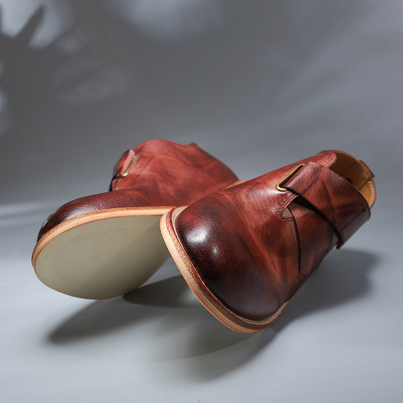 Pair of brown leather shoes on a gray background