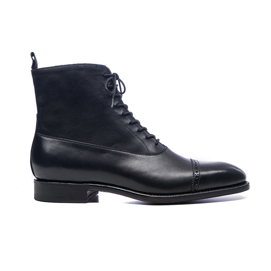 Black leather boot on a white background