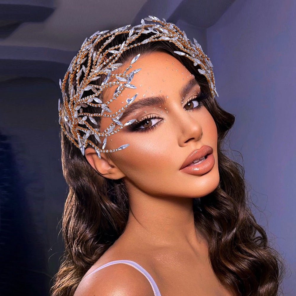 Woman wearing a decorative headpiece against a dark background
