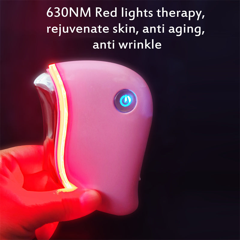 Pink device with red light therapy feature held by a hand, on a dark background.