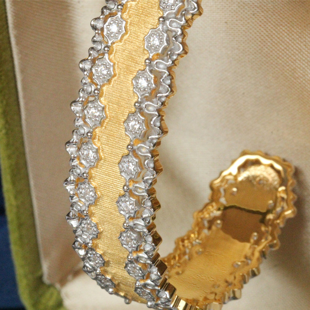 Gold and silver bracelet on a beige fabric background