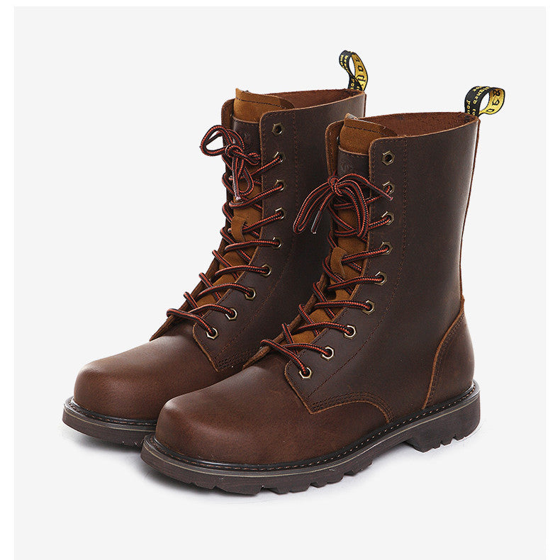 Pair of brown leather boots with laces on a white background