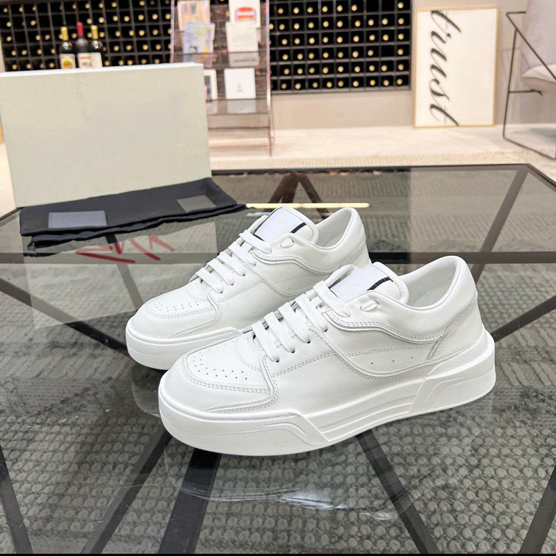 White sneakers on a glass table with a blurred background