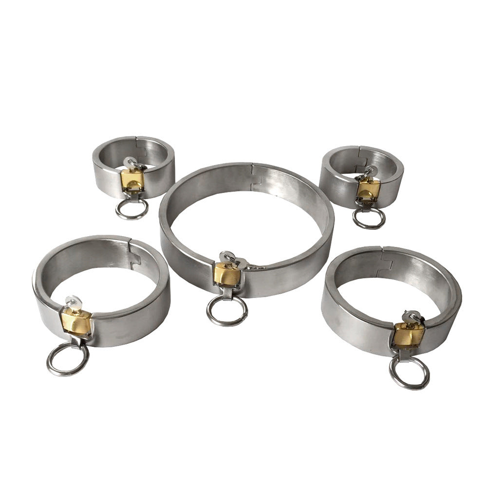 Set of metal cuffs with gold hardware on a white background