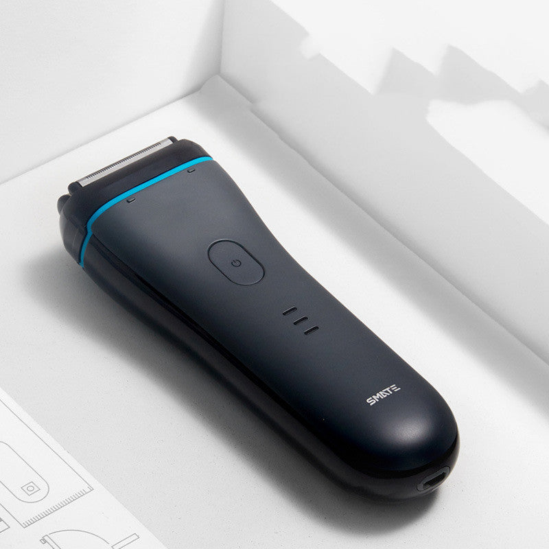 Black electric shaver with blue accent on a white surface