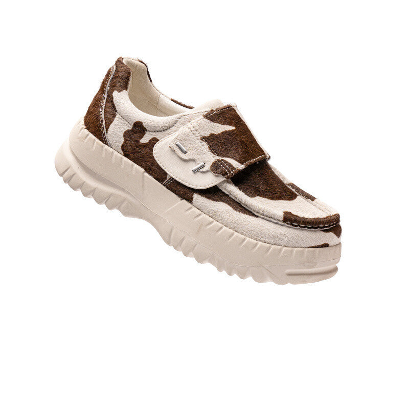 Brown and white cow print sneaker on a white background