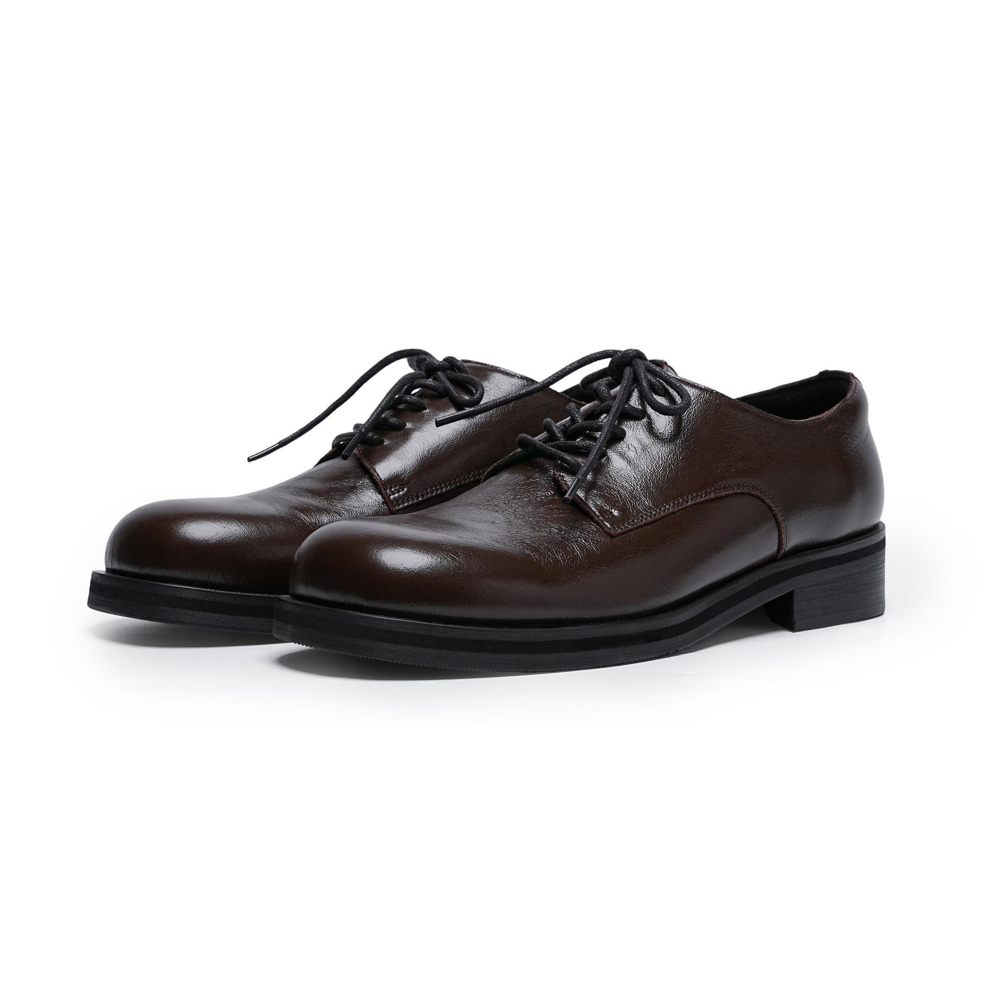 Pair of brown leather dress shoes on a white background