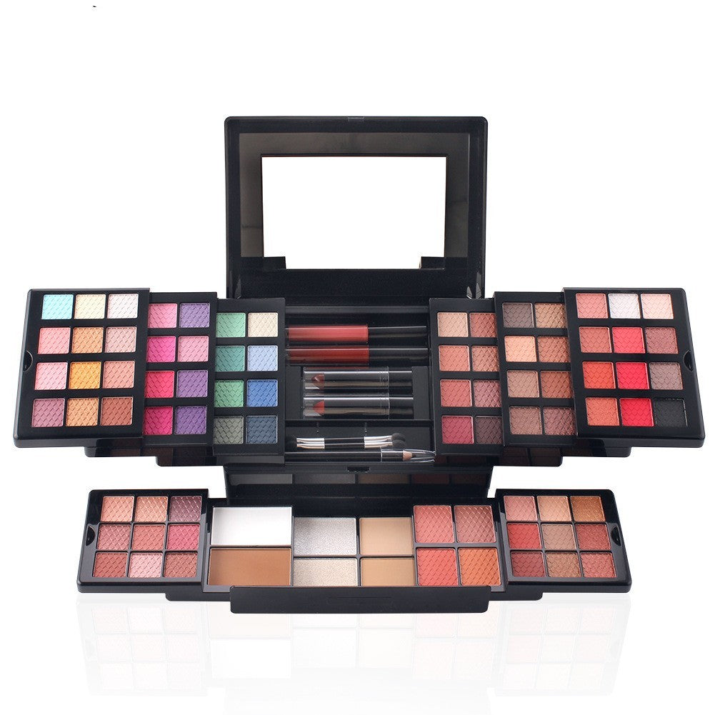 Makeup palette with various color swatches and brushes on a white background