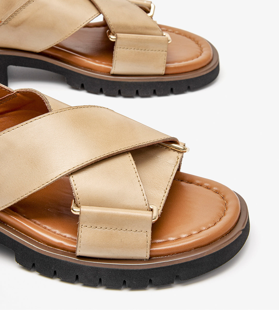 Beige sandals with brown soles on a light gray background