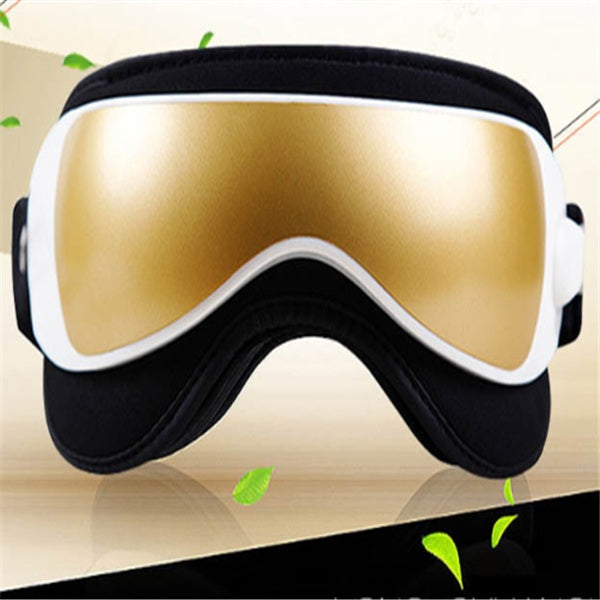 Gold ski goggles with black frame on a beige background