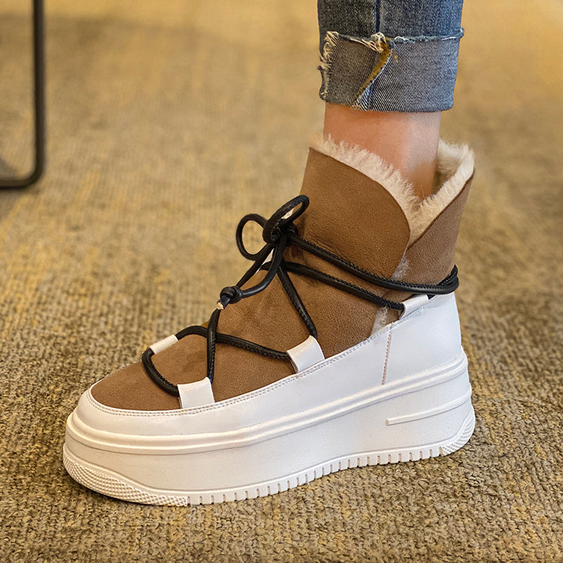 Brown and white sneaker with fur lining worn on a carpeted floor