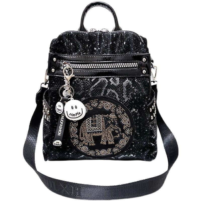 Black glittery backpack with decorative elements on a white background