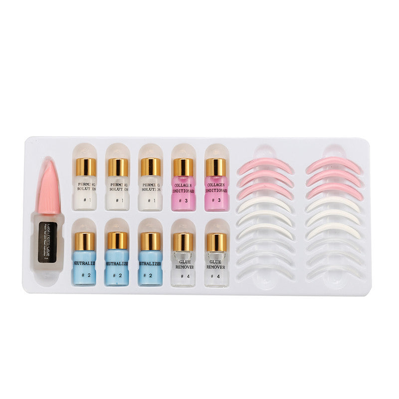 Set of false eyelashes with adhesive applicators on a white background