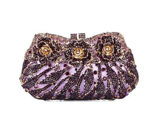 Decorative clutch bag with floral pattern and purple accents on a white background