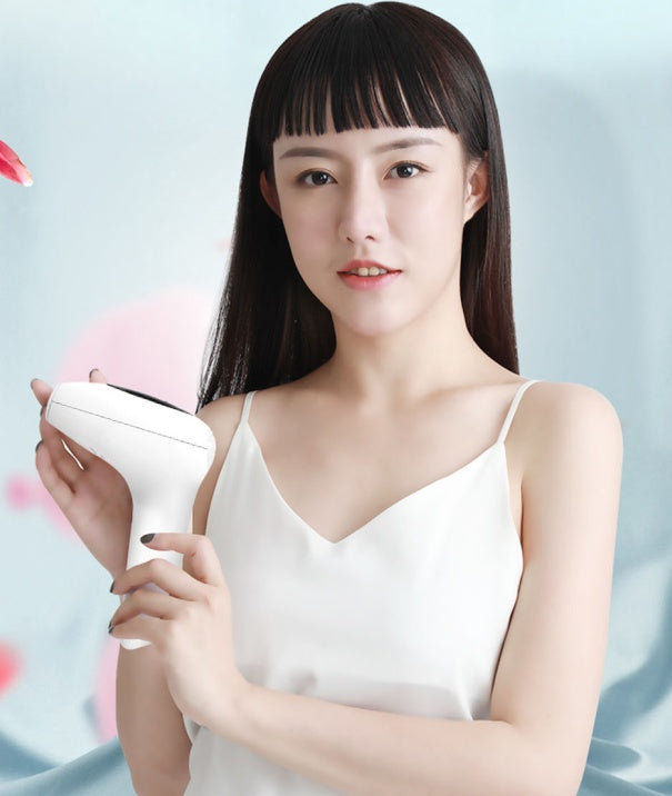 Woman holding a white handheld device against a light blue background
