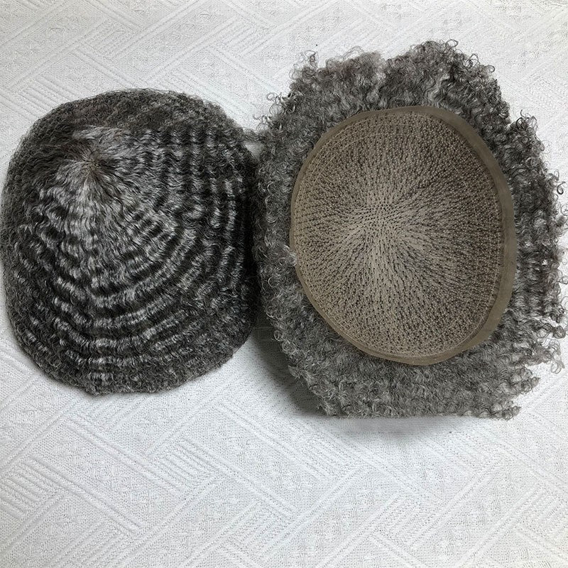 Two textured knit hats on a textured white surface