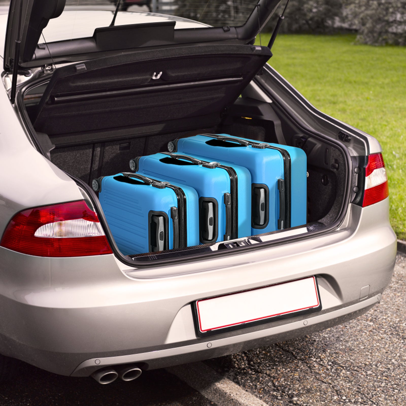 Open car trunk with blue suitcases inside