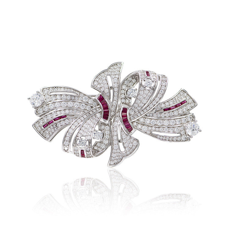 Diamond and ruby brooch on a white background