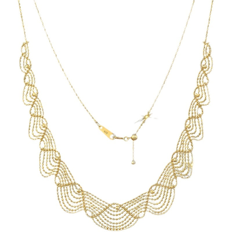 Gold beaded necklace on a white background